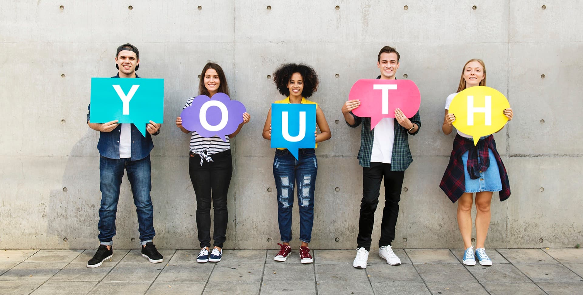 Five young people holding up the letters Y, O, U, T, H